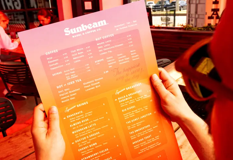 person holding the Fuoco Restaurant & Coffee Co. Menu