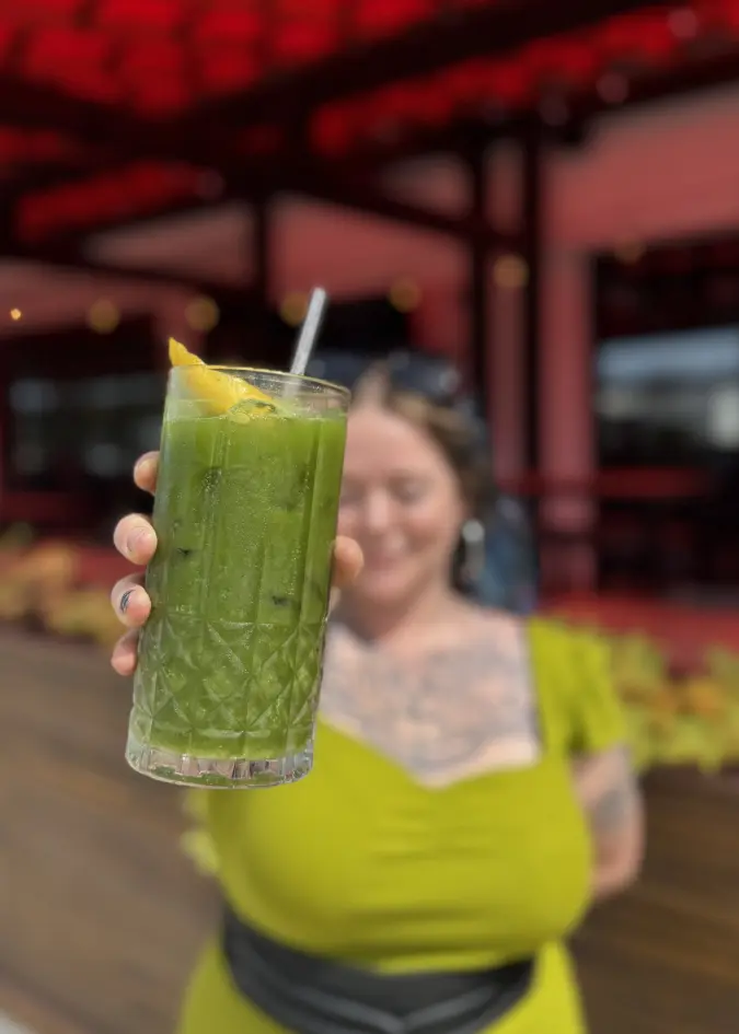 Person holding a matcha drink outside of Fuoco